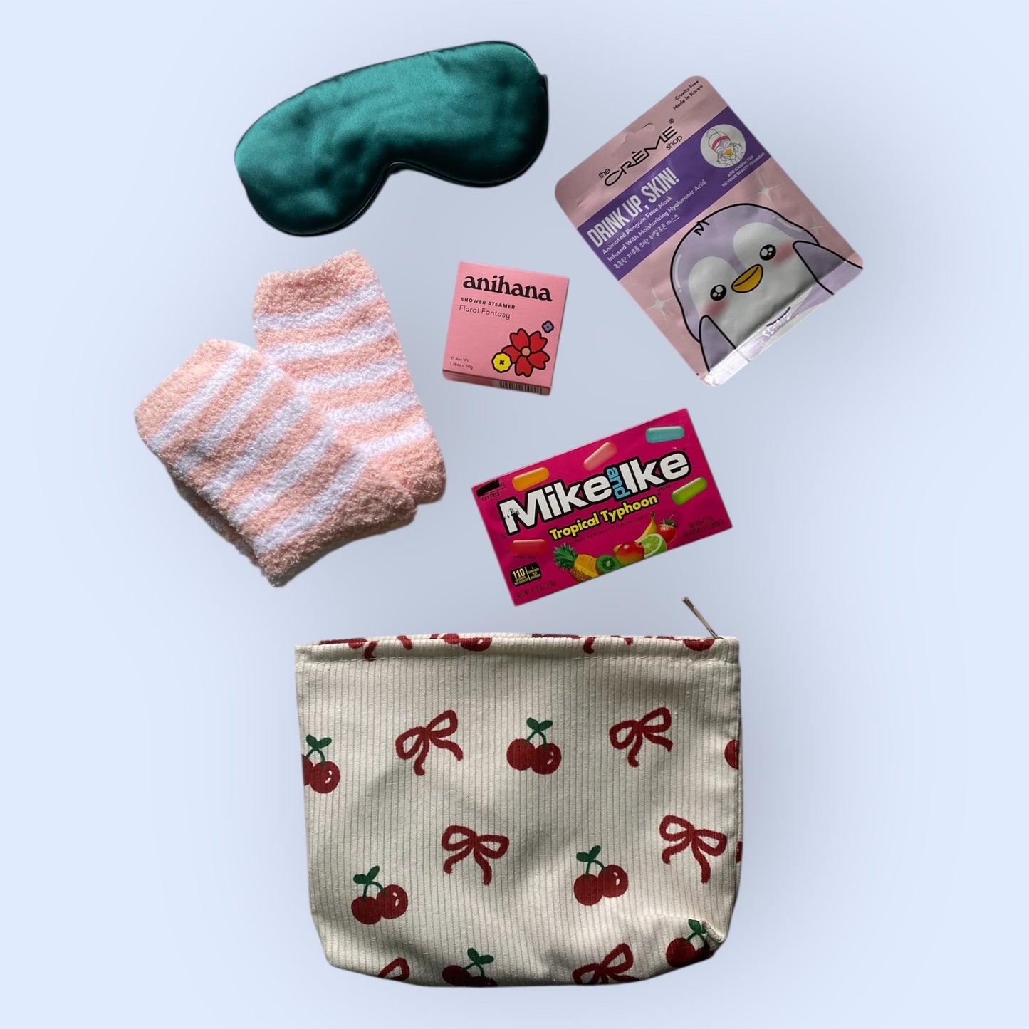 Toilet bag, face mask, fluffy socks, eye mask, shower steamer and mike and ike american candy.
