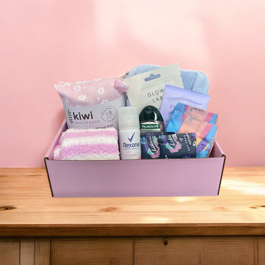 Gift box of period gift box. Wheatbag, fluffy socks, pads, liners, body spray, hand sanitiser, purse for pads. 